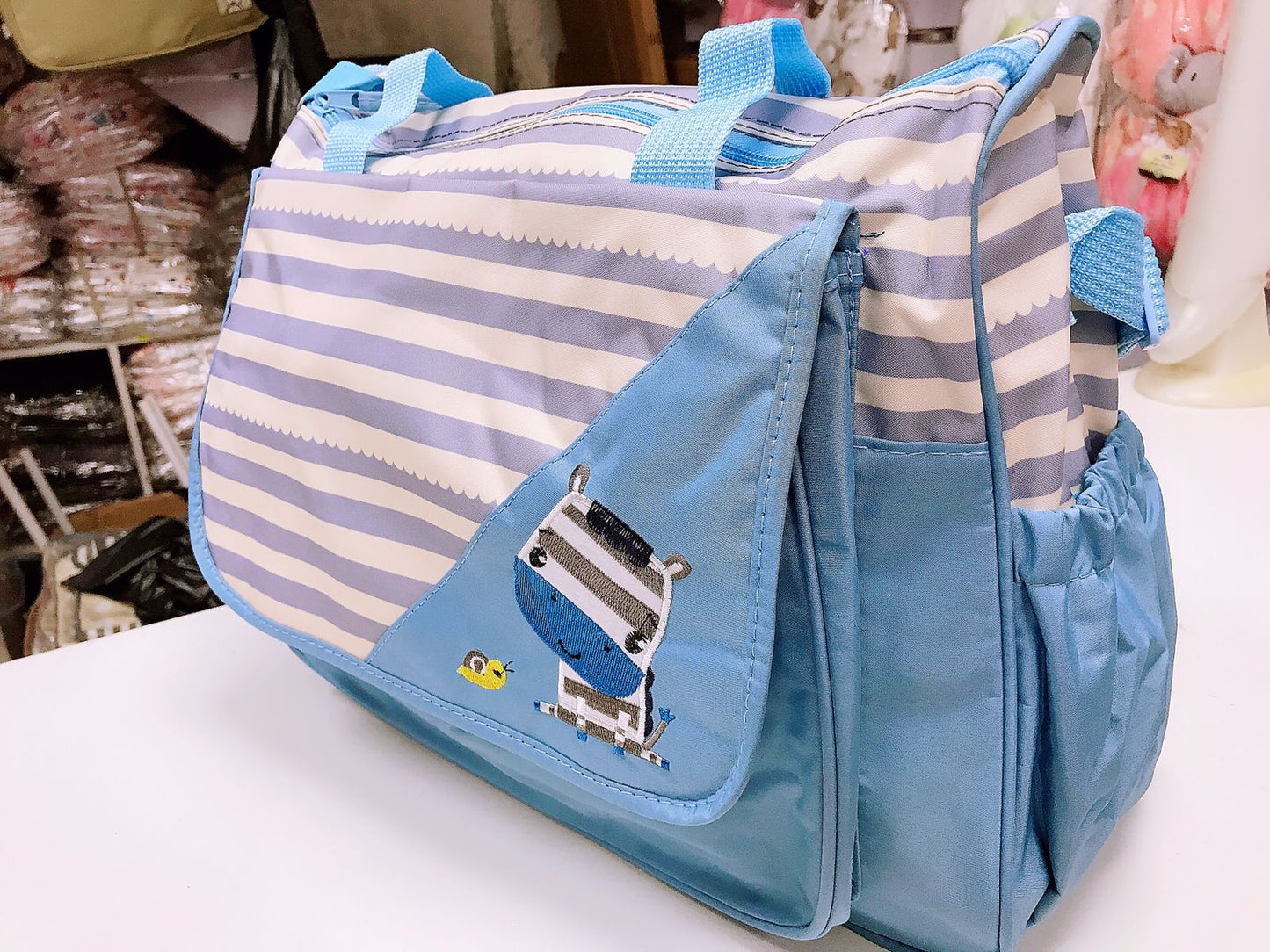 Bolso maternal + Mudador cebra celeste